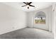 A bedroom with neutral walls, plush carpeting, and a window with an arched top at 3528 Tack St, Las Vegas, NV 89122