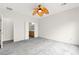 Neutral bedroom with gray carpet, ceiling fan, and access to the ensuite bathroom at 3528 Tack St, Las Vegas, NV 89122