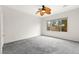 Spacious bedroom with large window, ceiling fan, and neutral carpet at 3528 Tack St, Las Vegas, NV 89122