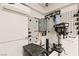 Garage featuring an air conditioner, water heater, work bench, and tool storage at 3528 Tack St, Las Vegas, NV 89122