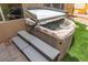 Close-up of a hot tub with steps, set in a landscaped backyard at 3528 Tack St, Las Vegas, NV 89122