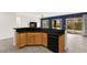 Kitchen counter with bar stools overlooks large living area with views to the backyard at 3528 Tack St, Las Vegas, NV 89122