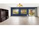 Spacious living room features large windows, a media center, and sliding doors to the backyard at 3528 Tack St, Las Vegas, NV 89122