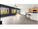 Open-concept living space with bright blue accent wall and bar seating, perfect for entertaining guests at 3528 Tack St, Las Vegas, NV 89122