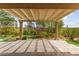 Back patio covered by a pergola, surrounded by a landscaped yard at 3528 Tack St, Las Vegas, NV 89122