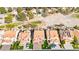 Aerial view of a residential area showcasing houses with red-tiled roofs near a golf course and desert landscape at 5492 Royal Vista Ln, Las Vegas, NV 89149