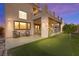 Backyard featuring a covered patio, putting green, seating area, and a well-manicured lawn at 5492 Royal Vista Ln, Las Vegas, NV 89149