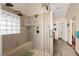 Enjoy this updated shower featuring bench seating, dual shower heads, and frosted window at 5492 Royal Vista Ln, Las Vegas, NV 89149