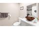 This is a bathroom with a vessel sink, modern fixtures, and a shower with glass doors and marble-look surround at 5492 Royal Vista Ln, Las Vegas, NV 89149