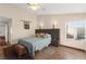 Cozy bedroom with a queen-size bed, ceiling fan, and a window overlooking the backyard at 5492 Royal Vista Ln, Las Vegas, NV 89149