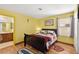 A cozy bedroom featuring a queen-sized bed with decorative pillows, a TV, and an ensuite bathroom at 5492 Royal Vista Ln, Las Vegas, NV 89149