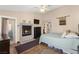 Comfortable bedroom featuring a fireplace, ceiling fan, and outdoor access to patio or balcony at 5492 Royal Vista Ln, Las Vegas, NV 89149