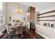 Elegant dining room with a fireplace, chandelier, and a table set for six at 5492 Royal Vista Ln, Las Vegas, NV 89149