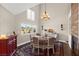 Bright dining room with vaulted ceiling, fireplace, and views of the backyard at 5492 Royal Vista Ln, Las Vegas, NV 89149