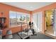 A brightly lit exercise room features a treadmill and other workout equipment near a window with neighborhood views at 5492 Royal Vista Ln, Las Vegas, NV 89149