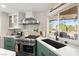 Bright kitchen with stainless steel appliances, unique backsplash, and a large sink overlooking the backyard at 5492 Royal Vista Ln, Las Vegas, NV 89149
