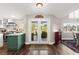 The spacious kitchen features stainless steel appliances, green cabinetry, and views of the patio at 5492 Royal Vista Ln, Las Vegas, NV 89149
