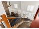 Open-concept living room with a fireplace, large windows, and a staircase leading to the upper level at 5492 Royal Vista Ln, Las Vegas, NV 89149