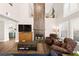 Cozy living room with a decorative fireplace, hardwood floors and plantation shutters at 5492 Royal Vista Ln, Las Vegas, NV 89149