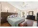 Spacious main bedroom with a king-size bed, ceiling fan, and access to a private balcony at 5492 Royal Vista Ln, Las Vegas, NV 89149