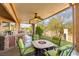 Covered patio with a built-in grill, ceiling fans, outdoor seating, and a fire pit for entertaining at 5492 Royal Vista Ln, Las Vegas, NV 89149
