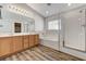 Bright bathroom features wood-look floors, dual sinks, soaking tub, and glass shower at 6267 Dollar Bill Ct, Las Vegas, NV 89141