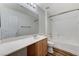 Bright bathroom featuring a modern sink, wood cabinets, and a shower over a tub at 6267 Dollar Bill Ct, Las Vegas, NV 89141