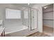 Well-lit bathroom features a soaking tub with a glass shower door and walk in closet at 6267 Dollar Bill Ct, Las Vegas, NV 89141