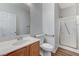 Clean bathroom with a white sink, toilet, and a glass-enclosed shower with accessibility bars at 6267 Dollar Bill Ct, Las Vegas, NV 89141