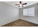 Neutral bedroom with plank floors and a ceiling fan provides a serene and comfortable space at 6267 Dollar Bill Ct, Las Vegas, NV 89141