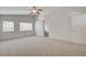 Inviting bedroom with neutral carpet, ceiling fan, and two windows allowing ample natural light at 6267 Dollar Bill Ct, Las Vegas, NV 89141