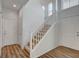 Bright entryway with wood laminate flooring and a stairway leading to the upper level at 6267 Dollar Bill Ct, Las Vegas, NV 89141