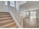 Inviting entryway with carpeted stairs leading to a well-lit living area featuring plank flooring at 6267 Dollar Bill Ct, Las Vegas, NV 89141