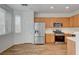 Well-equipped kitchen with stainless steel refrigerator and oak cabinets at 6267 Dollar Bill Ct, Las Vegas, NV 89141