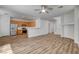 Open floor plan featuring a kitchen with stainless steel appliances and wood laminate flooring at 6267 Dollar Bill Ct, Las Vegas, NV 89141