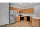 Kitchen showcasing stainless steel appliances, oak cabinetry and a white tile backsplash at 6267 Dollar Bill Ct, Las Vegas, NV 89141