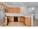Close-up of the kitchen with stainless steel appliances and oak cabinetry at 6267 Dollar Bill Ct, Las Vegas, NV 89141