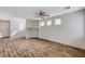 Open-concept living area with wood laminate flooring, staircase, and abundant natural light at 6267 Dollar Bill Ct, Las Vegas, NV 89141