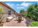 Backyard patio with outdoor seating surrounded by green shrubs and trees at 703 Shiva St, Las Vegas, NV 89178