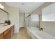 Bright bathroom with double sinks, a soaking tub, and a separate shower at 703 Shiva St, Las Vegas, NV 89178