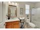 Well-lit bathroom featuring a vanity with a wood cabinet and a glass-enclosed shower at 703 Shiva St, Las Vegas, NV 89178