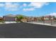 Inviting single-story home featuring desert landscaping and a neutral color palette, complemented by mountain views in the background at 703 Shiva St, Las Vegas, NV 89178