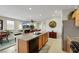 Open-concept kitchen with an island breakfast bar flowing seamlessly into the living area at 703 Shiva St, Las Vegas, NV 89178
