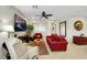 Cozy living room featuring comfortable seating, a ceiling fan, and tiled floors at 703 Shiva St, Las Vegas, NV 89178