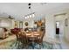 Bright open living space with dining table, kitchen view, and comfortable seating with tile flooring and natural lighting at 703 Shiva St, Las Vegas, NV 89178