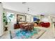 Open living space showcases a dining table and chairs, plush sofa seating, tile flooring, and natural lighting at 703 Shiva St, Las Vegas, NV 89178