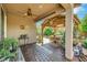 Outdoor patio with a ceiling fan, seating area under a pergola, brick pavers, and mature landscaping at 703 Shiva St, Las Vegas, NV 89178