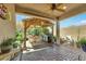 Outdoor patio with seating, grill, covered pergola, mature landscaping, and brick pavers at 703 Shiva St, Las Vegas, NV 89178