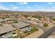 Aerial view showcases a residential neighborhood, houses with pools, and mountain views at 7477 Triple Knot Ct, Las Vegas, NV 89113