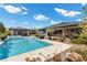 Stunning backyard oasis with pool, spa, lounging area, and lush landscaping for ultimate outdoor living at 7477 Triple Knot Ct, Las Vegas, NV 89113